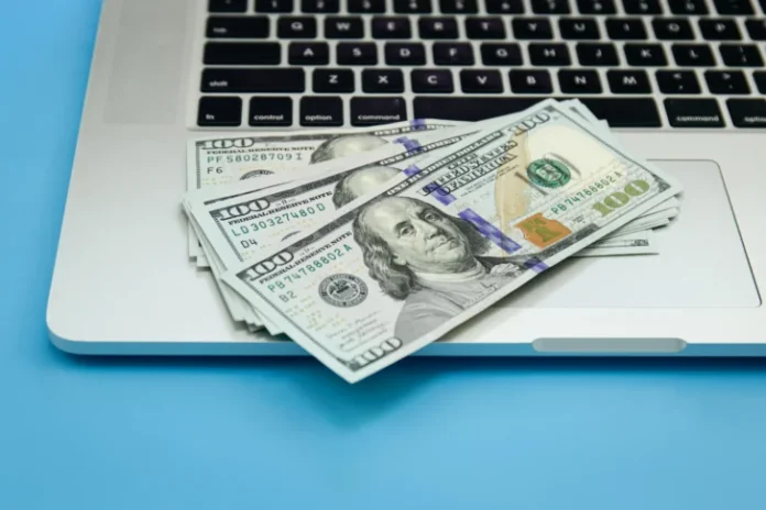 close-up-dollar-bills-laptop-money-making-concept-728x485-2